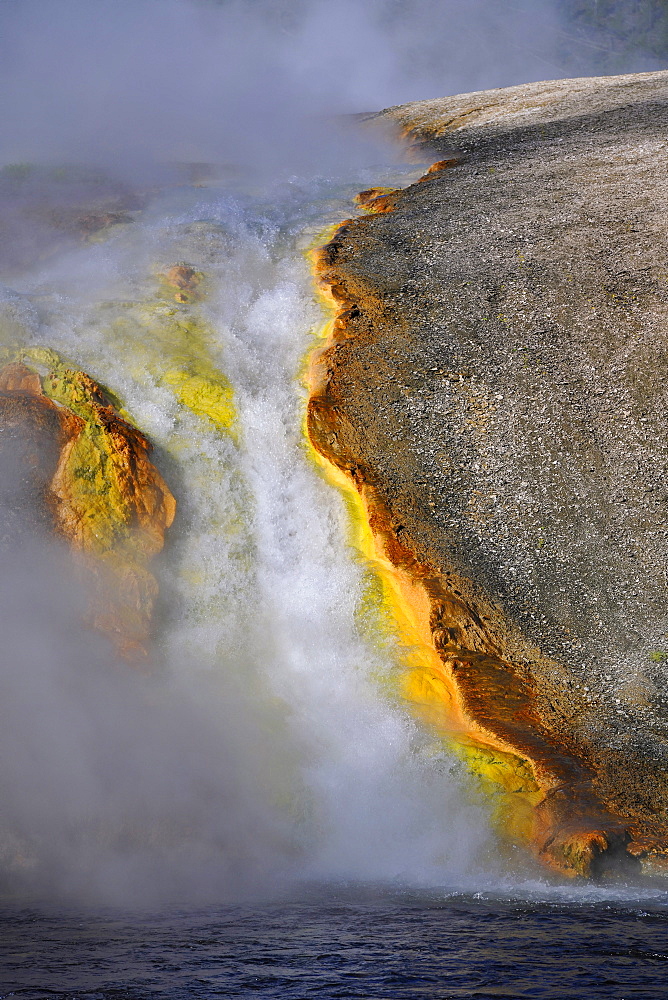 Runoff from Excelsior Geyser into Firehole River, Midway Geyser Basin, colored thermophilic bacteria, microorganisms, geysers, hot springs, Yellowstone National Park, Wyoming, United States of America, USA