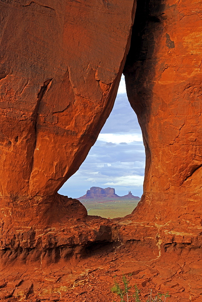 Looking through the Tear Drop Arch towards the Mesas in Monument Valley, Arizona, USA