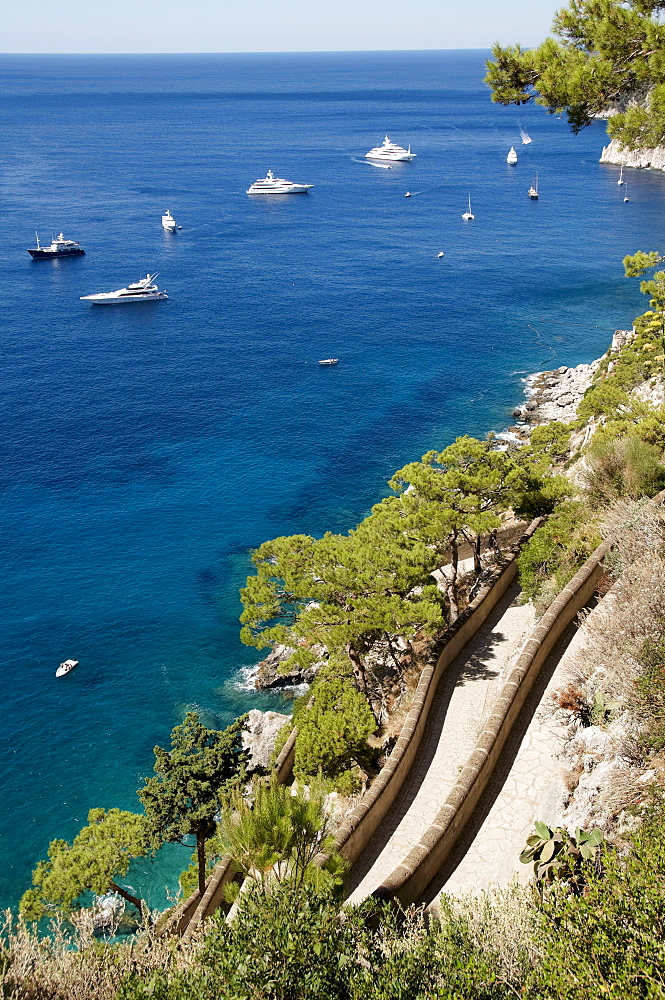 View over Via Krupp with boats in the bay in front of Marina Piccola, island of Capri, Italy, Europe