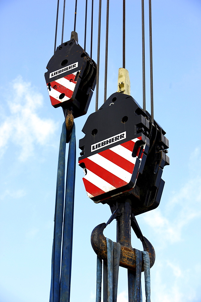 Crane hooks of a large mobile crane with rope loops to secure loads