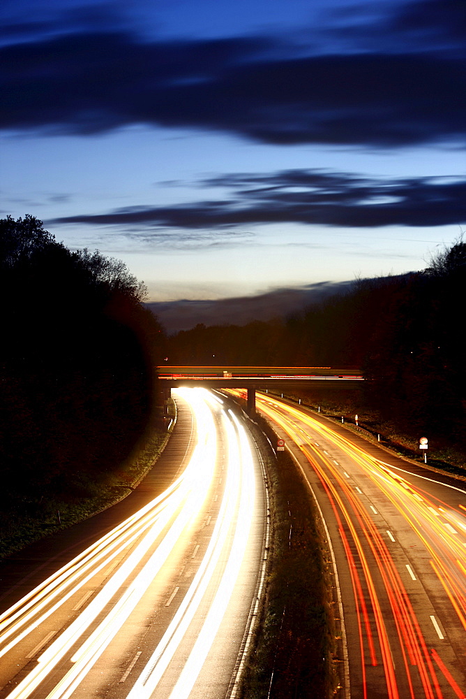 Evening traffic on a motorway at nightfall, A52 motorway, Essen, North Rhine-Westphalia, Germany, Europe