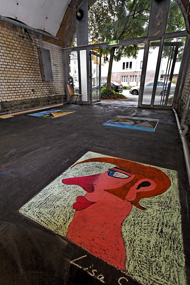 Pedestrian tunnel with chalk drawings on the ground, painted by children, disused Suedbahnhof railway station, Krefeld, North Rhine-Westphalia, Germany, Europe