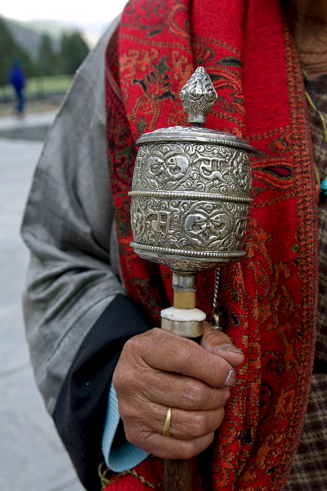 Buddhist pilgrim holding a prayer wheel, Thimpu, Bhutan, Asia