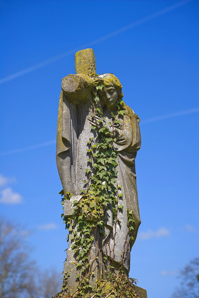 Gravestone of angel holding cross, St Mary's graveyard, Andover, Hampshire, England, United Kingdom, Europe