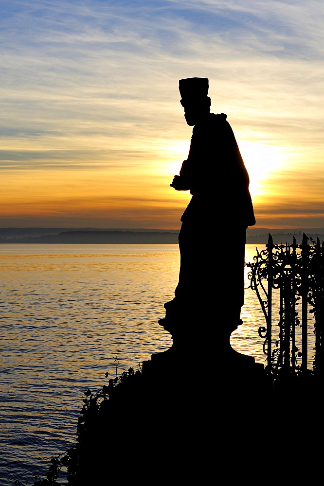 Silhouette of the holy statue of St. Nepomuk, patron saint of bridges on the banks of Meersburg, in front of Lake Constance, Lake Constance district, Baden-Wuerttemberg, Germany, Europe