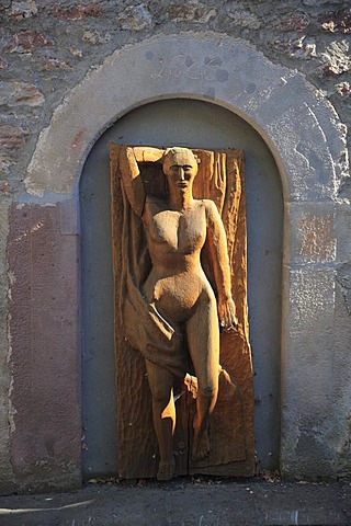 Wood sculpture of a woman's body on the Zehntturm tithe tower in Bischofsheim an der Rhoen, Rhoen-Grabfeld district, Lower Franconia, Bavaria, Germany, Europe