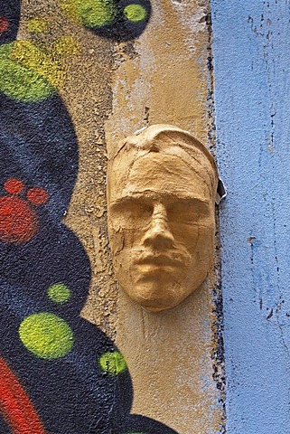 Mask of a male face in the courtyard of a building