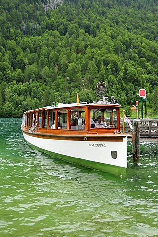 Electric boat "Salzburg" of the Koenigssee-Schifffahrt line at the pier at the pilgrimage church of St. Bartholomae, Koenigssee lake, Nationalpark Berchtesgaden Alpine national park, Bavaria, Germany, Europe