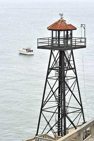 Watchtower and fishing boat at sea, Alcatraz Island, California, USA