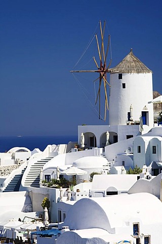 Windmill in between cafes and restaurants, Oia, Santorini, Cyclades, Greece, Europe