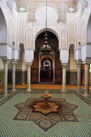 Partial view, interior with wash fountain and columns with stucco ornaments and tile mosaics in the mausoleum Mulay Ismail, Meknes, Morocco, Africa