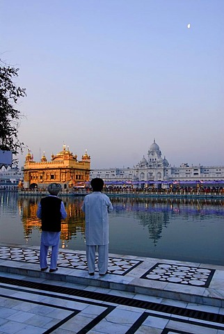 Sikhs looking at the Golden Temple, Amritsar, India, Asia