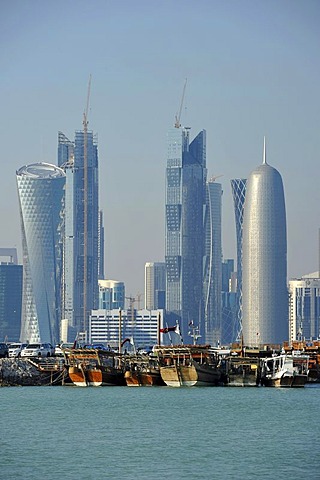 Tradition and modernity, dhow wooden cargo ships in front of the skyline of Doha, Qatar, Persian Gulf, Middle East, Asia