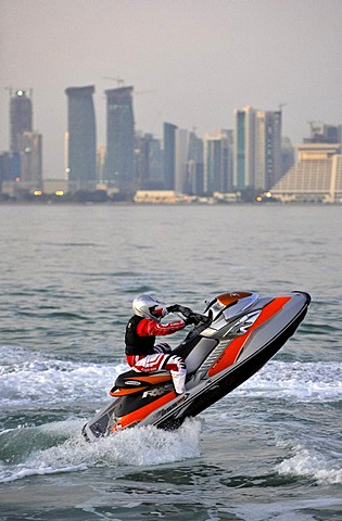 Jet-skiing, jetboat, personal watercraft in front of the skyline of Doha, Qatar, Persian Gulf, Middle East, Asia