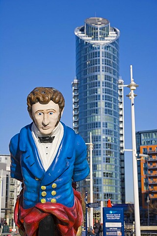 Figurehead from the former HMS Vernon ship at canalside of Gunwharf Quays with The Number One Tower, Lipstick, at back, Portsmouth, Hampshire, England, United Kingdom, Europe