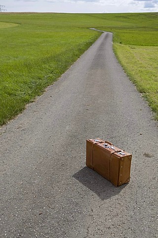 Suitcase, country road, symbolic image Last trip, death