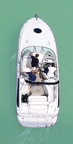 Three men in a motor boat, from above