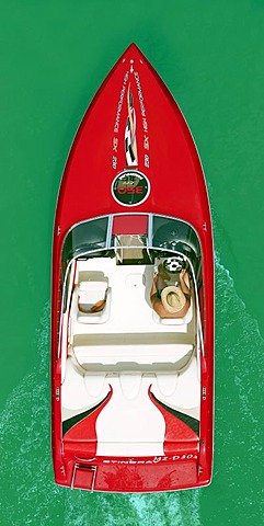 Man steering a motor boat, from above