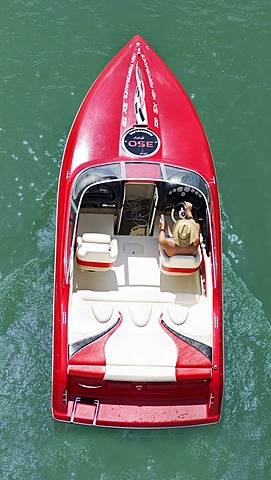 Man steering a motor boat, from above