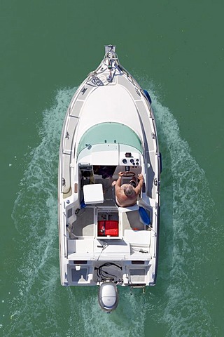 Man steering a motor boat, from above