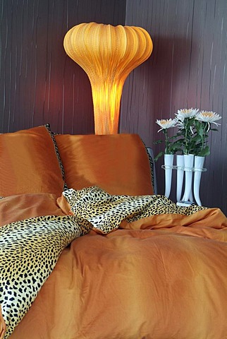 Luxurious bed in an exclusive design with a stylish lamp