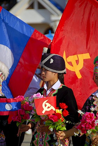 Girl of the Hmong ethnic group, traditional clothes with turban, Lao national flag, flag of the Communist Party, Xam Neua, Houaphan province, Laos, Southeast Asia, Asia