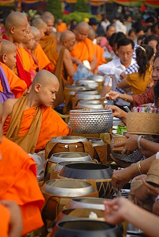 Theravada Buddhism, That Luang Festival, Tak Bat, monks standing behind alms bowls, hands, believers, pilgrims giving alms, orange robes, Vientiane, Laos, Southeast Asia, Asia