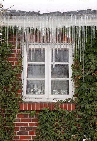 Residential house in winter with large icicles