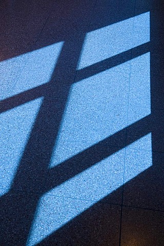 Window cross castings shadow on floor tiles