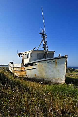 Old lobster boat on a meadow of Ile d'Entree, Entry Island, Iles de la Madeleine, Magdalen Islands, Quebec Maritime, Canada, North America