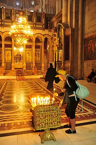 Christian pilgrim lights candle, Church of the Holy Sepulchre, Jerusalem, Israel, Middle East, Orient