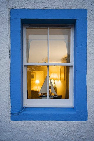 Illuminated window with miniature sailboat, Scotland, United Kingdom, Europe