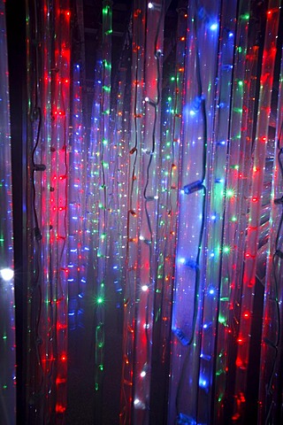 Maze, labyrinth made of colorful illuminated light rods, at a fair