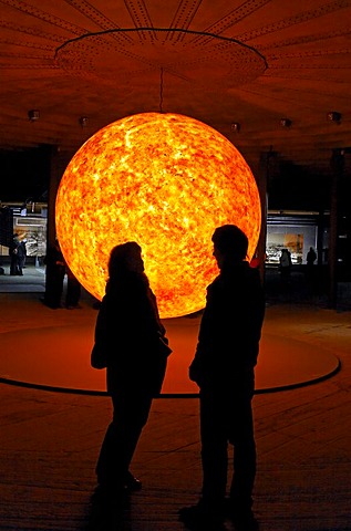 Two visitors looking at a replica of the sun, glowing ball, exhibition "Wunder des Sonnensystems" wonders of the solar system, Gasometer Oberhausen, Ruhrgebiet region, North Rhine-Westphalia, Germany, Europe