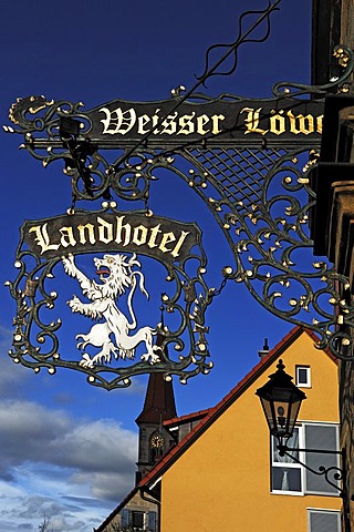 Inn sign "Weisser Loewe" against blue sky, Herrengasse 5, Eckental, Middle Franconia, Bavaria, Germany, Europe