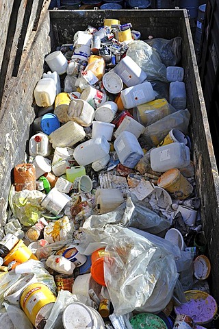 Paint cans and buckets, garbage in a collection container