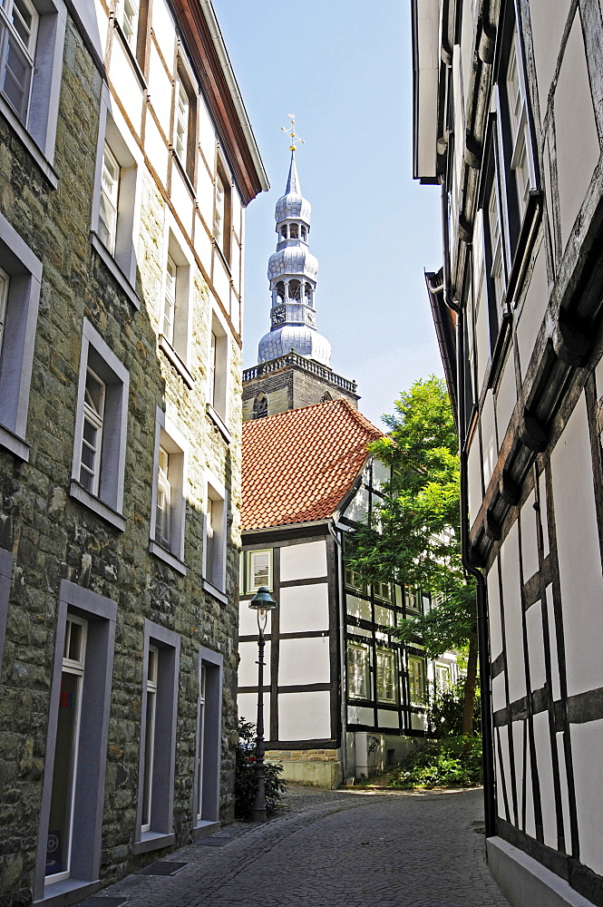 Narrow street, half-timbered houses, church tower, historic town centre, Soest, North Rhine-Westphalia, Germany, Europe