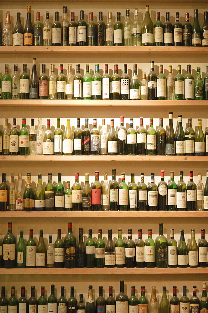 Many empty wine bottles on the shelves in the window of a wine restaurant, Vienna, Austria, Europe