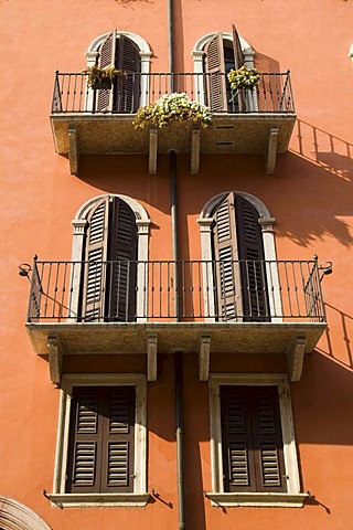 Orange house with twin windows in Venetian style, Verona, Veneto, Italy, Europe