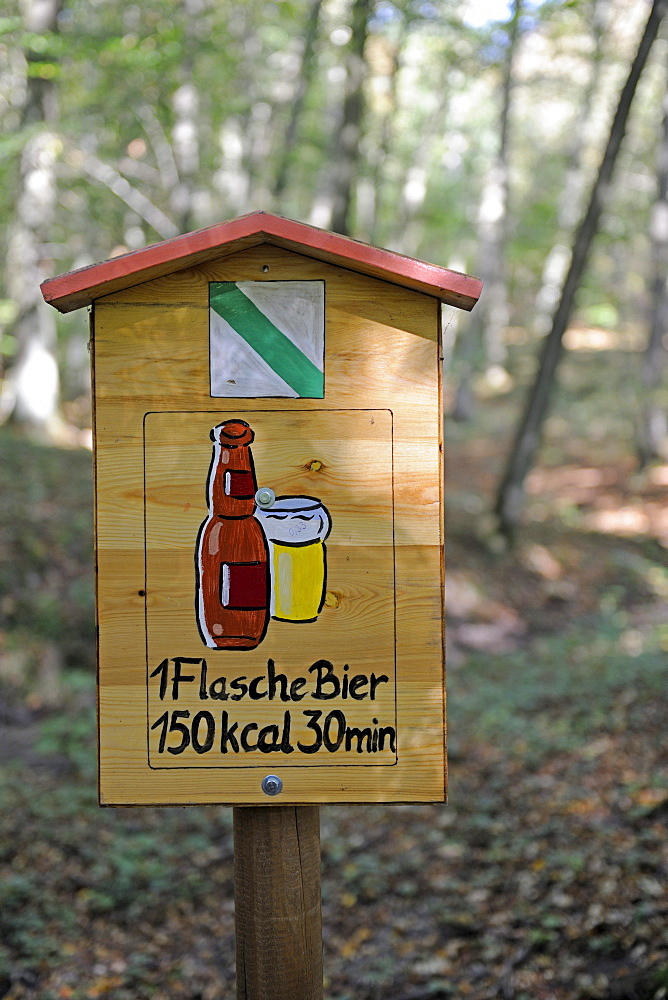 Sign on a hiking trail, shows the amount of time you need to walk off a beer