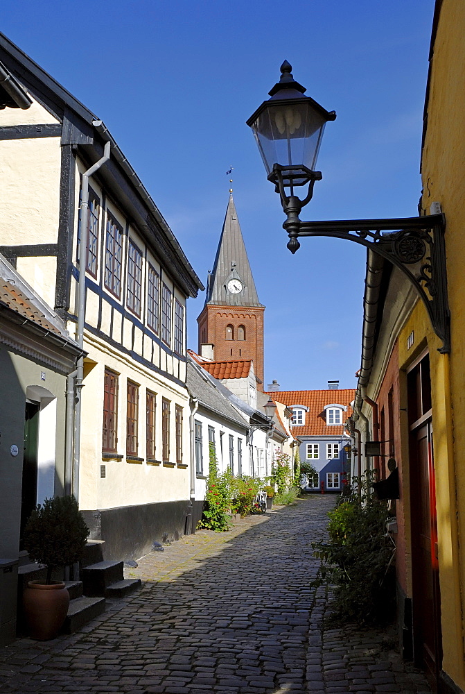 Cobblestone street in the historic town of Aalborg, Ã¢â€°Ë†lborg, in the back the Frue Kirke church, Nordjylland region, Denmark, Scandinavia, Europe