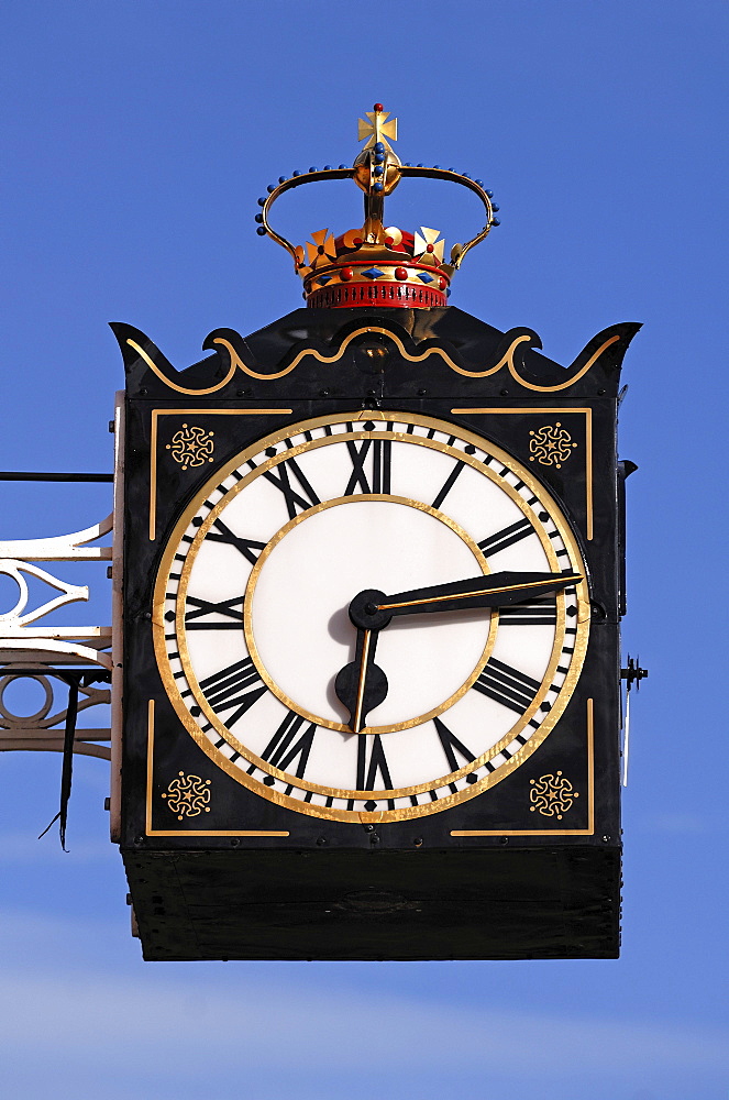 Old clock with a crown on a building against a blue sky, Chester Road, Brownhills, Staffordshire, England, United Kingdom, Europe