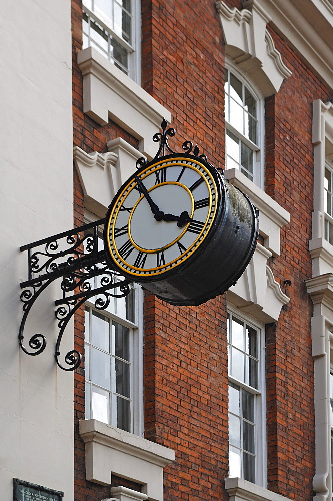 Old clock on a wall, Bore Street, Lichfield, Staffordshire, England, United Kingdom, Europe