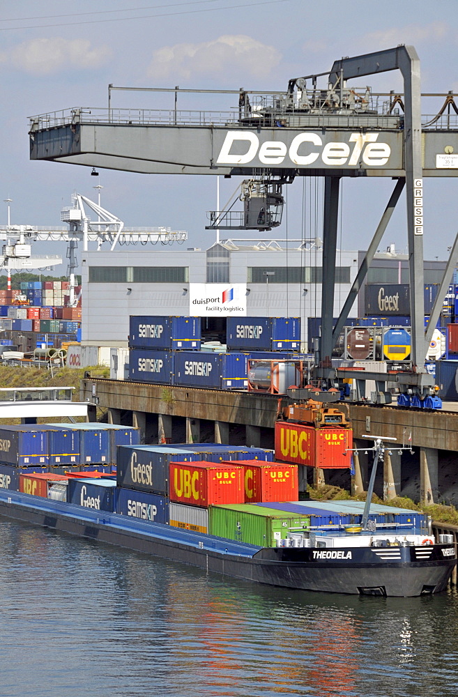 Cargo ship is being loaded, inland port in Duisburg, North Rhine-Westphalia, Germany, Europe