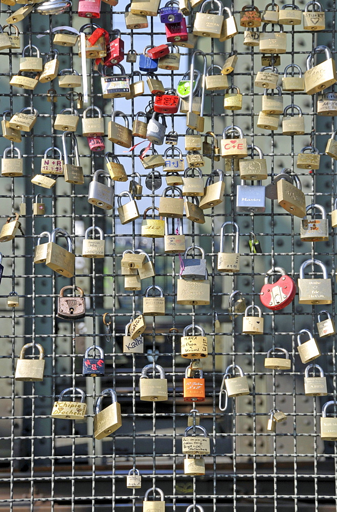 Padlocks as a sign of friendship and love at the metal fence of the Hohenzollernbruecke Hohenzollern Bridge in Cologne, North Rhine-Westphalia, Germany, Europe