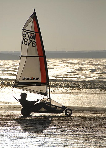 Person in sail wagon on the beach, silhouette, land sailing, sand yachting, Weston super Mare, Somerset, England, Great Britain, Europe