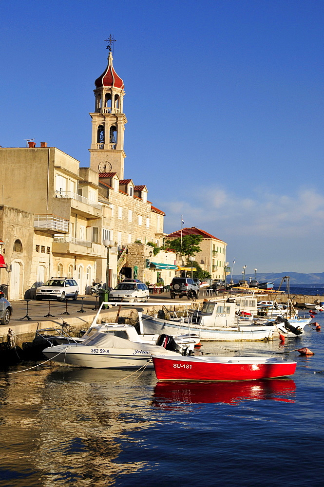 Fishing boats in the harbor of Sutivan in front of the church Sveti Ivan, Island Brac, Dalmatia, Croatia, Balkans, Europe