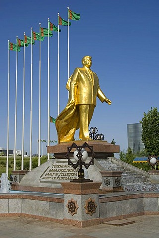 Gold covered statue of President Turkmenbasy in front of the monument of the 10th anniversary of Independence, Ashgabat, Turkmenistan