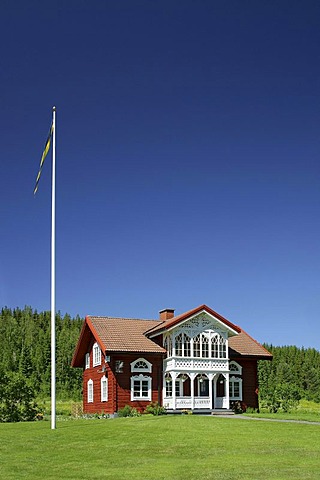 Wooden house with a flag in Sweden