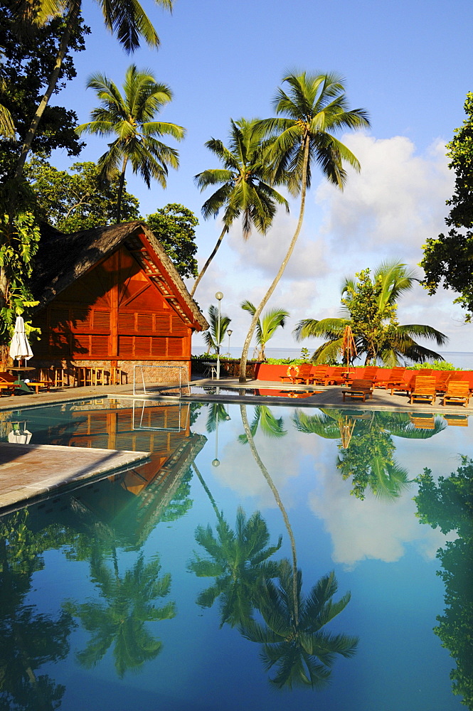 Coconut palms reflected in the pool, Berjaya Beau Vallon Bay Hotel, Mahe Island, Seychelles, Africa, Indian Ocean